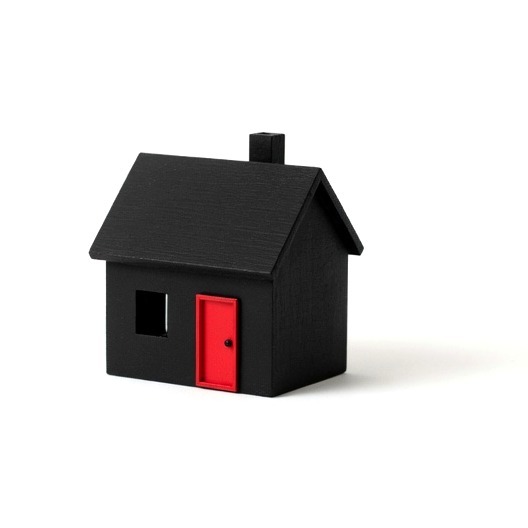 A small black model house with a single red front door on a white background